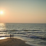 Couple on beach with Living Fayetteville.