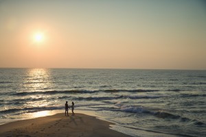 Couple on beach with Living Fayetteville.